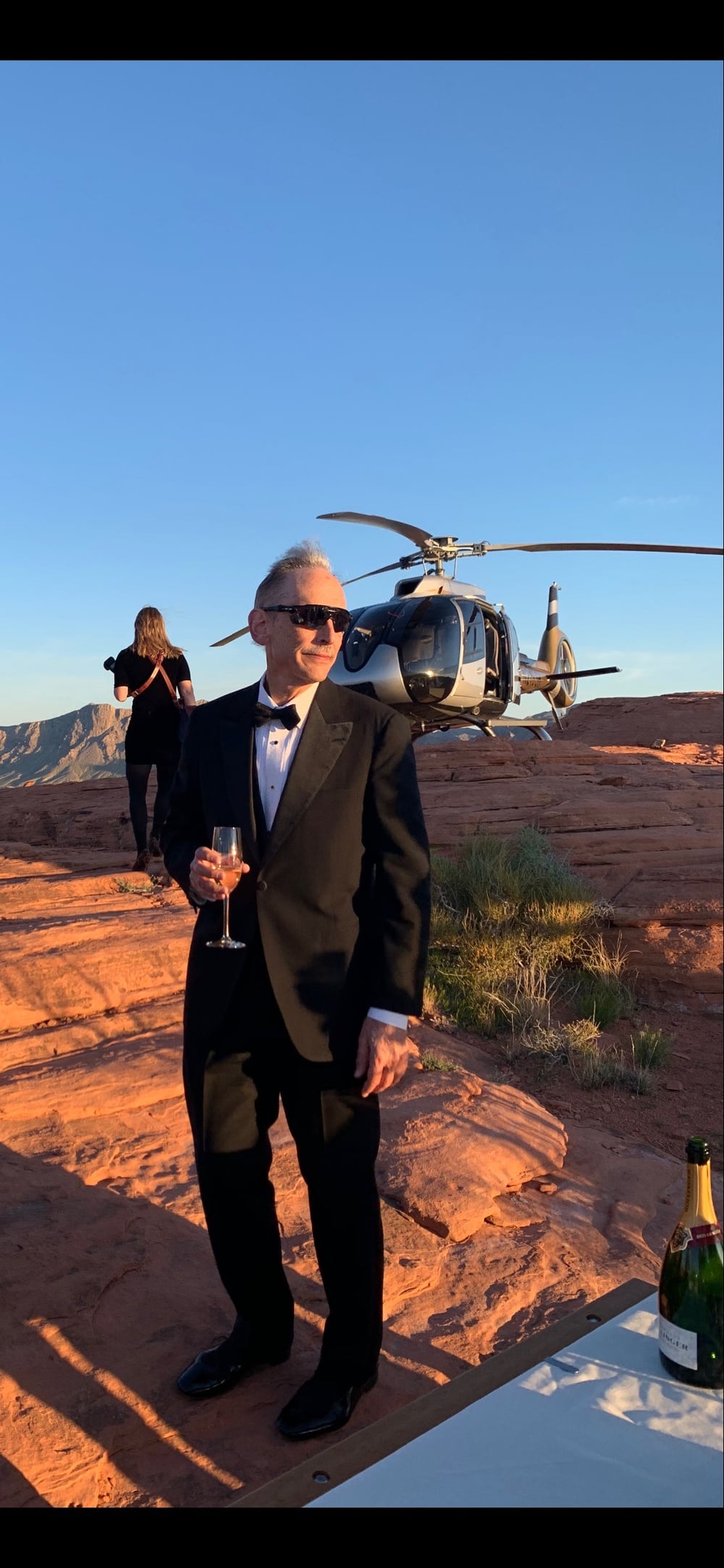 W. Hugh Woodin outdoors, wearing sunglasses and a tuxedo.